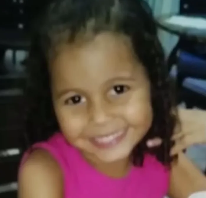Ana Clara Gomes Machado, sorrindo, de blusa rosa